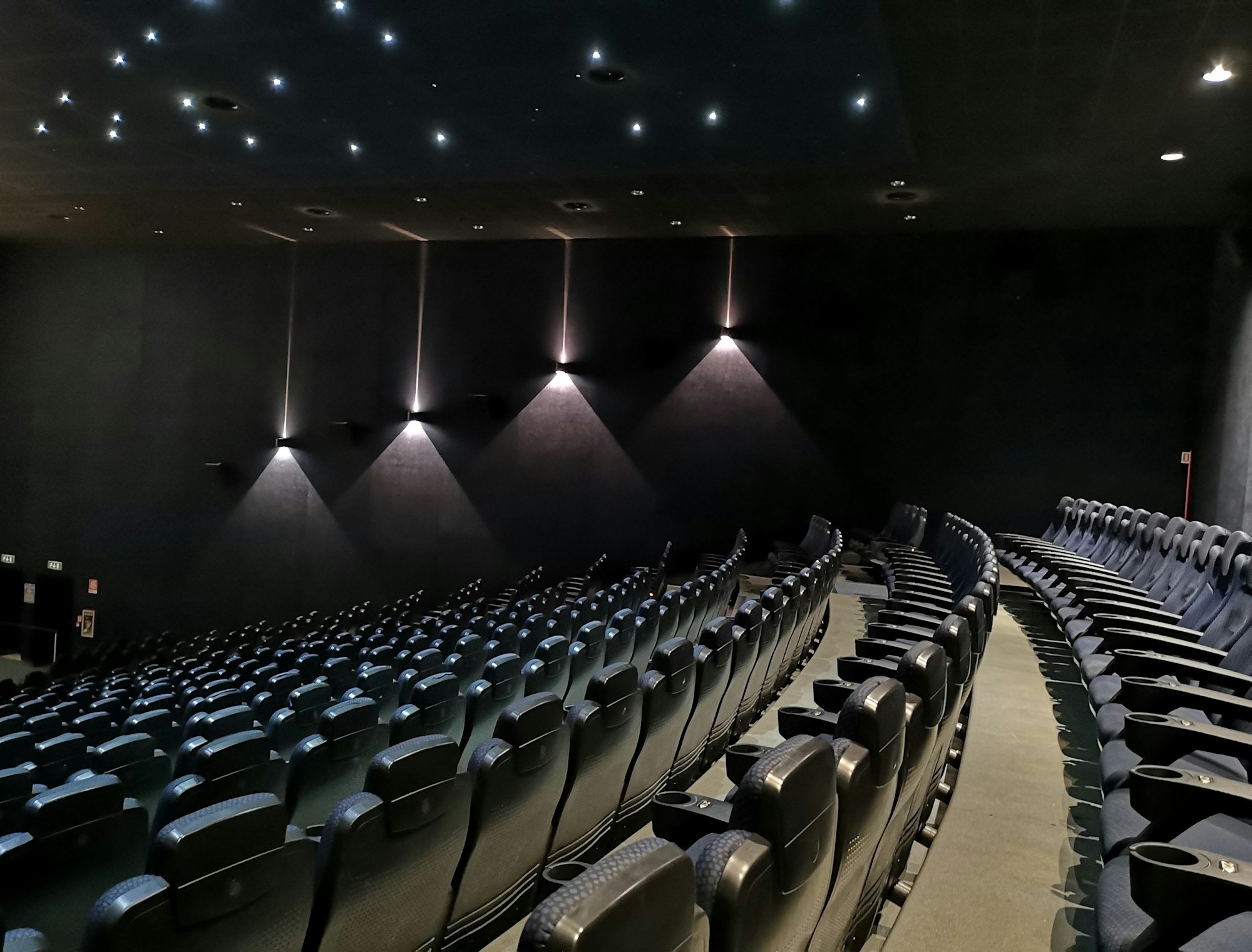 High angle shot of chairs with lights inside of a movie theater